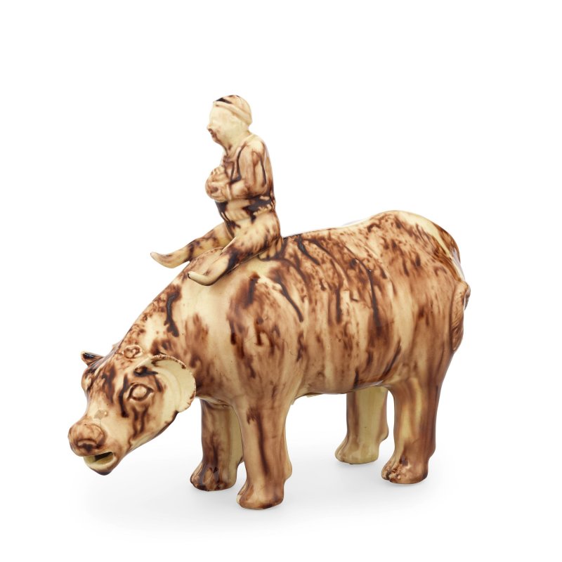 A Staffordshire Whieldon type creamware model of a boy riding a water buffalo, circa 1755-60