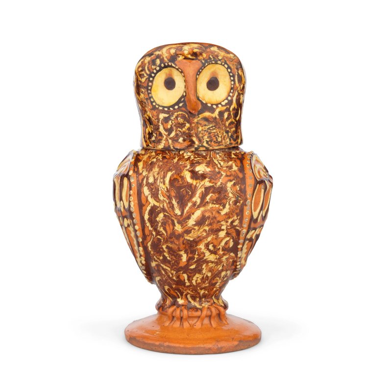 A remarkable Staffordshire slipware owl jug and cover, circa 1690-1710