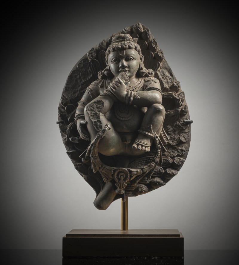 A STONE FIGURE OF KRISHNA