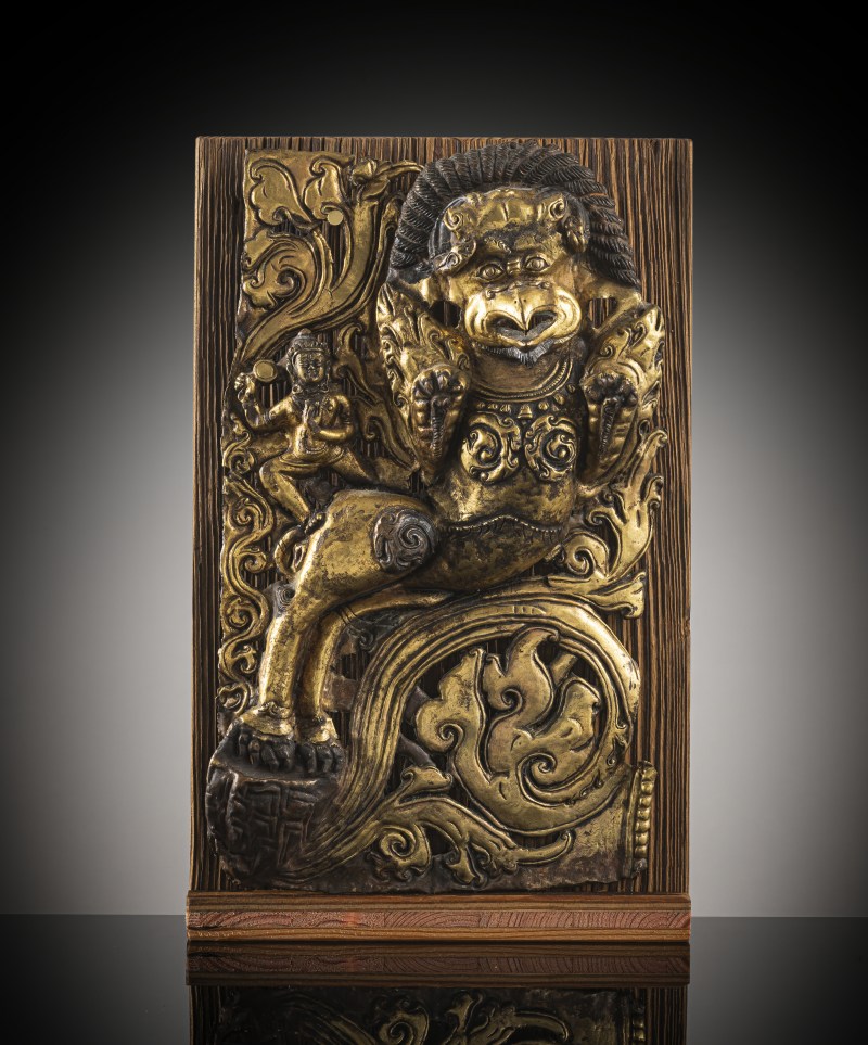 A GILT-COPPER EMBOSSED PANEL