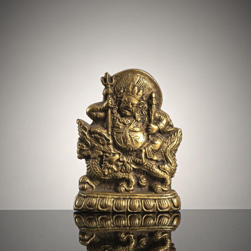 A BRONZE PLAQUE DEPICTING JAMBHALA