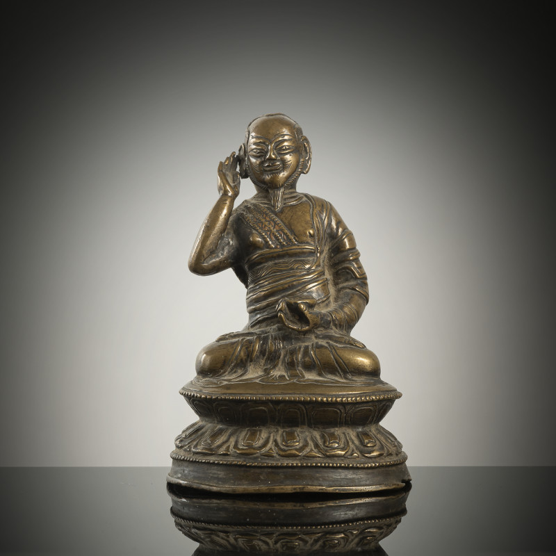 A BRONZE FIGURE OF A LAMA, POSSIBLY MILAREPA