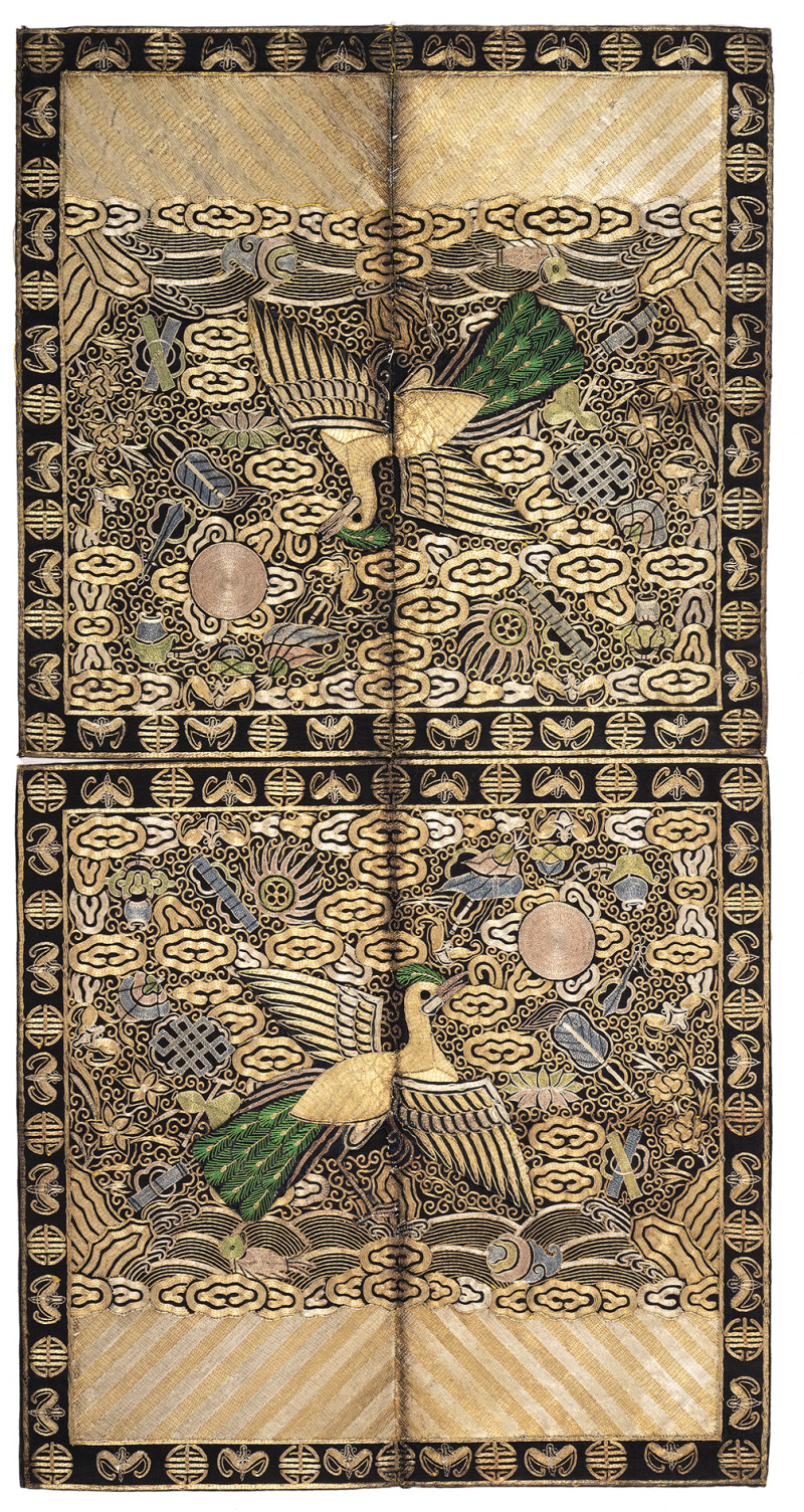 A pair of rank badges featuring peacocks embroidered in gold and silver