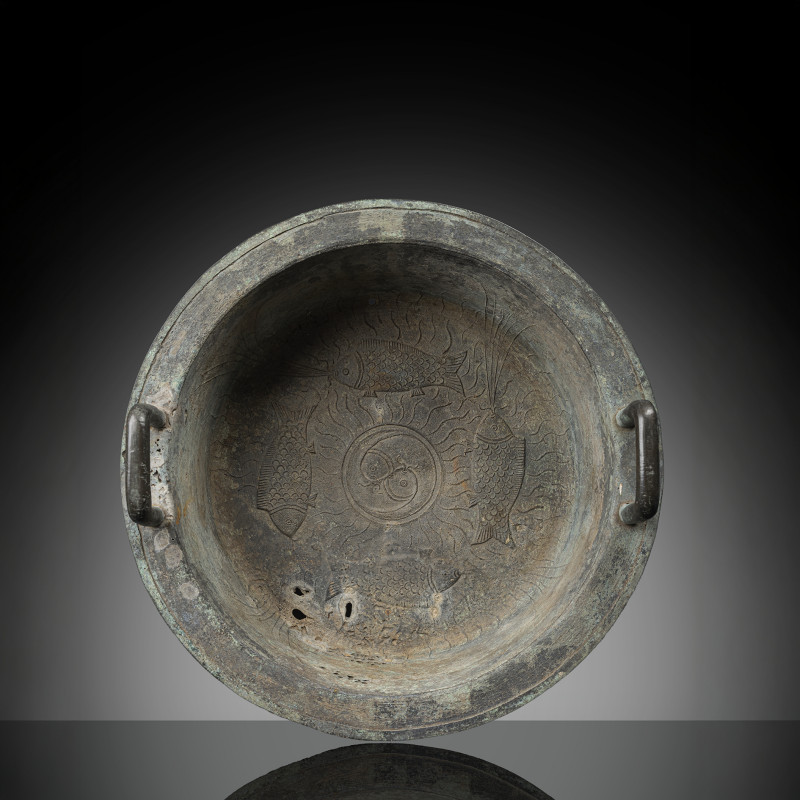 A bronze basin with relief and engraved decoration of fishes around a 'yin yang' symbol