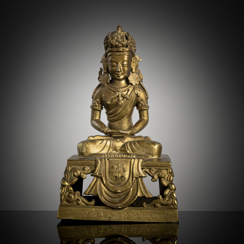 A gilt-bronze figure of Amitayus seated on a throne