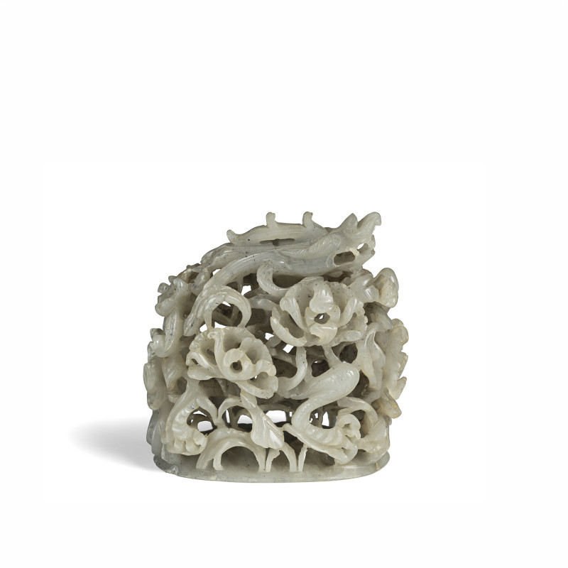 A fine carved jade handle with dragon between foliage and flowers