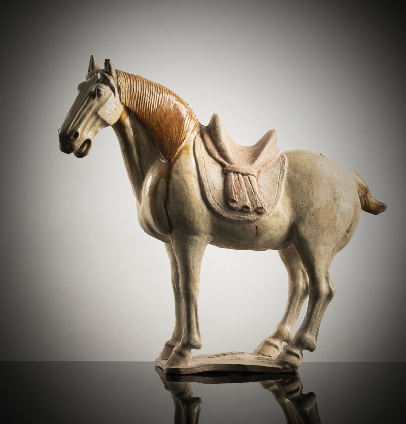 A partly amber-glazed earthenware figure of a standing horse