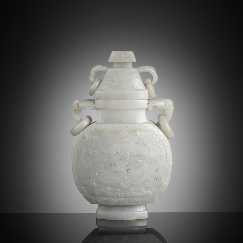 A well carved jade vase with ring handles and decoration of large 'Taotie' masks