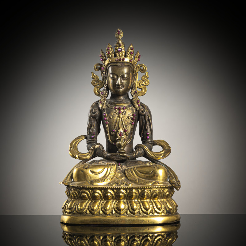 A part-gilt copper repoussé figure of Amitayus with glass and stone inlays