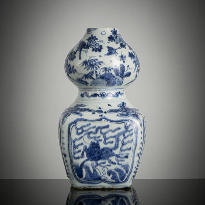 A double gourd vase with underglaze blue decoration of leaping horses over waves, flowers and fruits