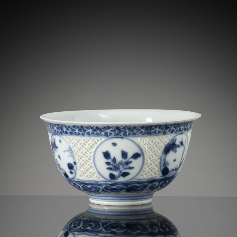 Underglaze blue porcelain bowl with reticulated cash lattice and floral medallions