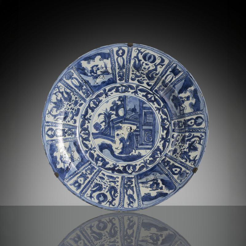 A Kraak plate decorated in underglaze blue with scholars and servant boys