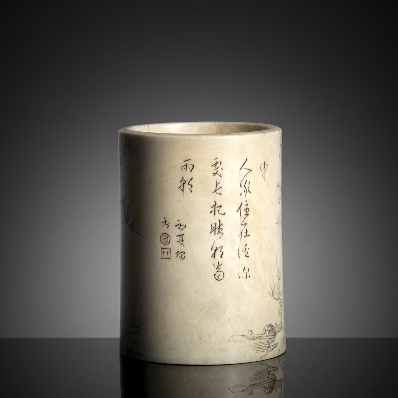 A cylindrical ivory brush pot with engraved decoration of a landscape and inscription