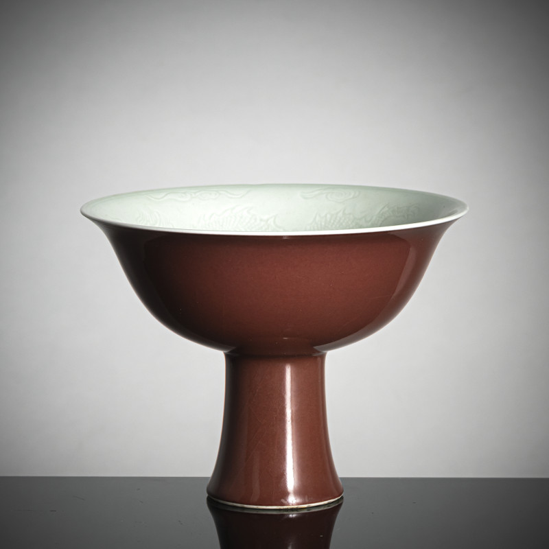 A copper-red glazed porcelain 'stemcup' with anhua decoration of dragons inside