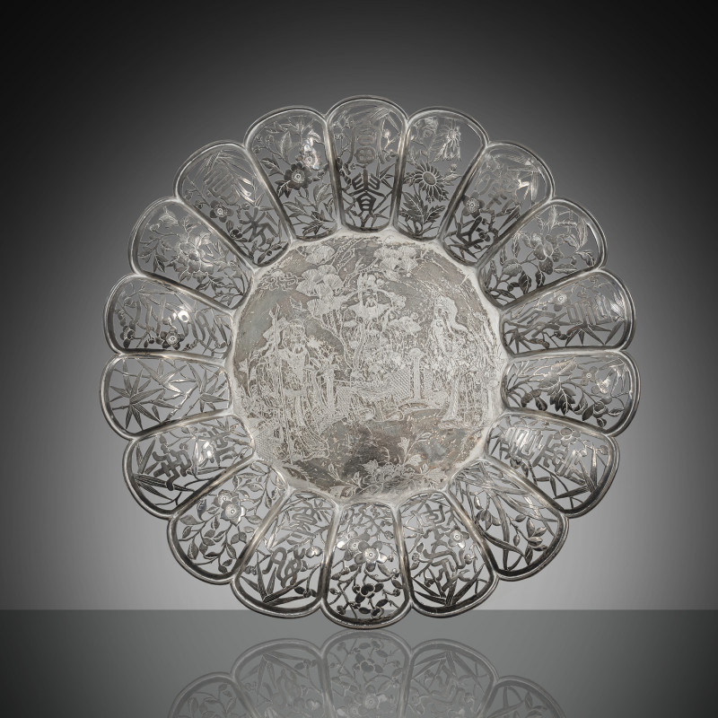 A chrysanthemum-shaped silver tray with 'Sanxing' or 'Fu Lu Shou' decoration