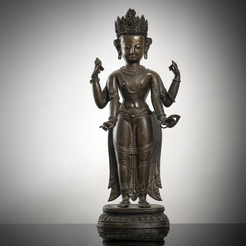 AN EMBOSSED COPPER FIGURE OF VISHNU
