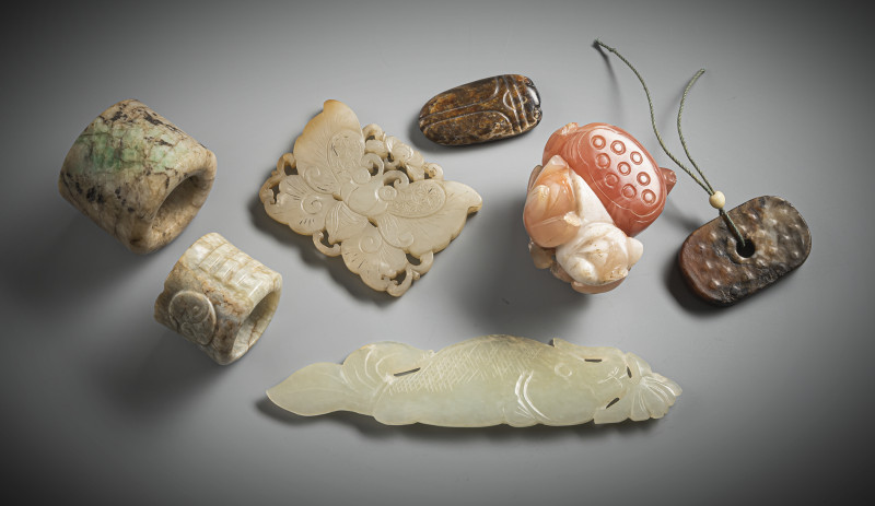 Six jade carvings, including two archer's rings and a carnelian lotus carving