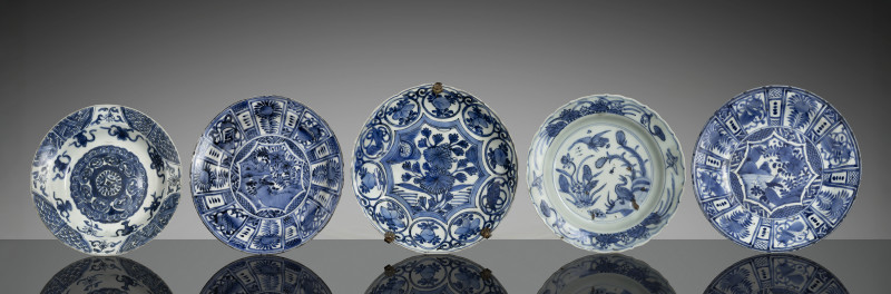 A group of five porcelain plates decorated in underglaze blue, partly Kraak ware