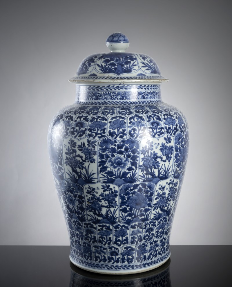 A large porcelain vase and cover decorated in underglaze blue with floral decoration in leaf-shaped reserves