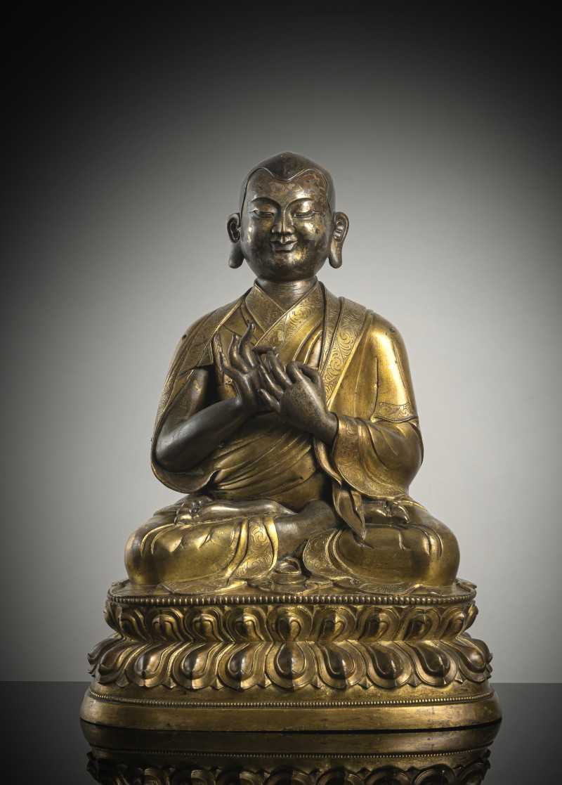 A large parcel gilt-bronze figure of a lama