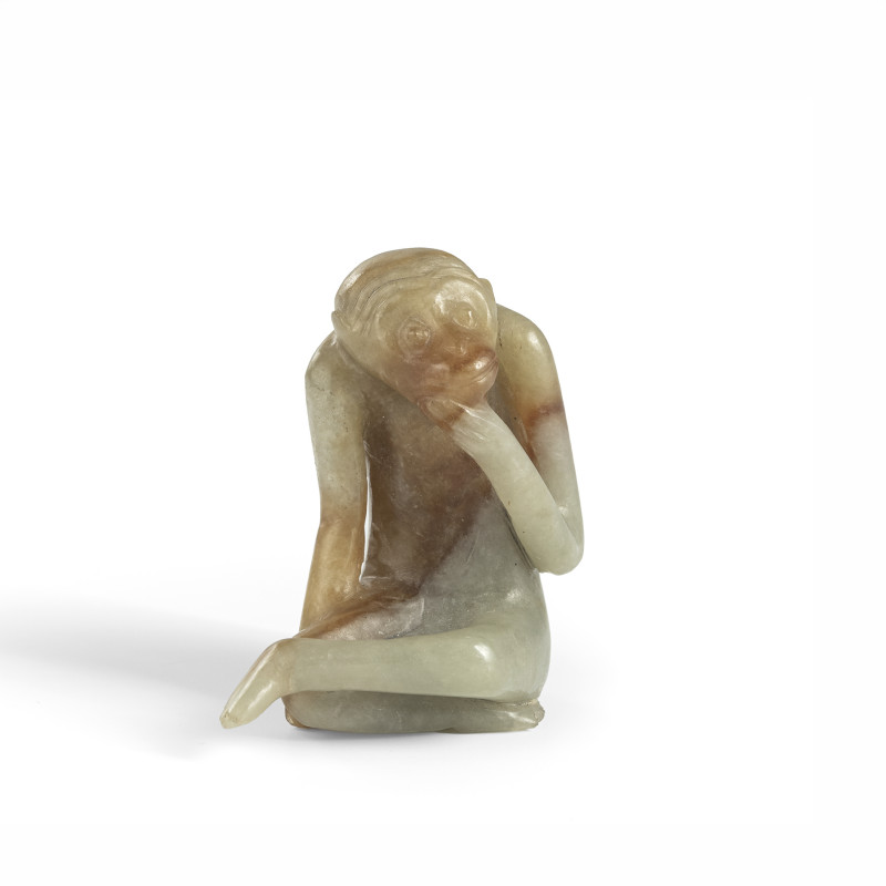 A sitting monkey carved from green caramel-coloured jade