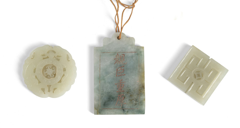 Three pendants made of jade or jadeite, one with the inscription