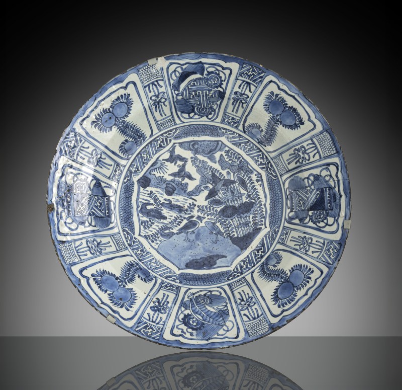 A large porcelain 'Kraak' charger decorated in underglaze blue with ducks and flowers