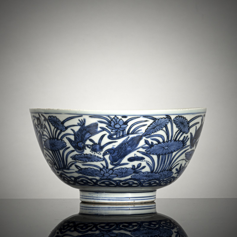 A fine decorated porcelain bowl with ducks in a lotus pond in strong underglaze blue