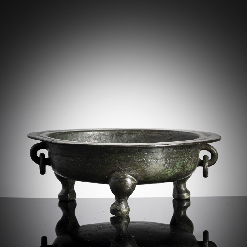 A twin-handled tripod bronze censer