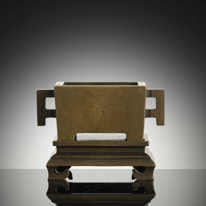 A rectangular twin-handled bronze censer with fitted bronze stand