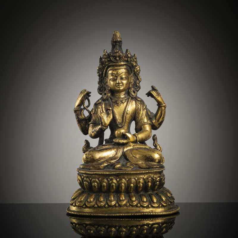 A gilt-bronze of a four-armed Bodhisattva