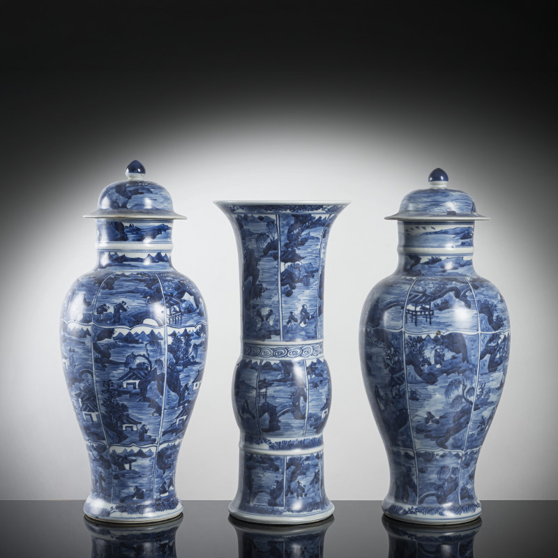 Set of two lidded vases and a 'gu'-shaped porcelain vase with underglaze blue decoration of scholar landscapes