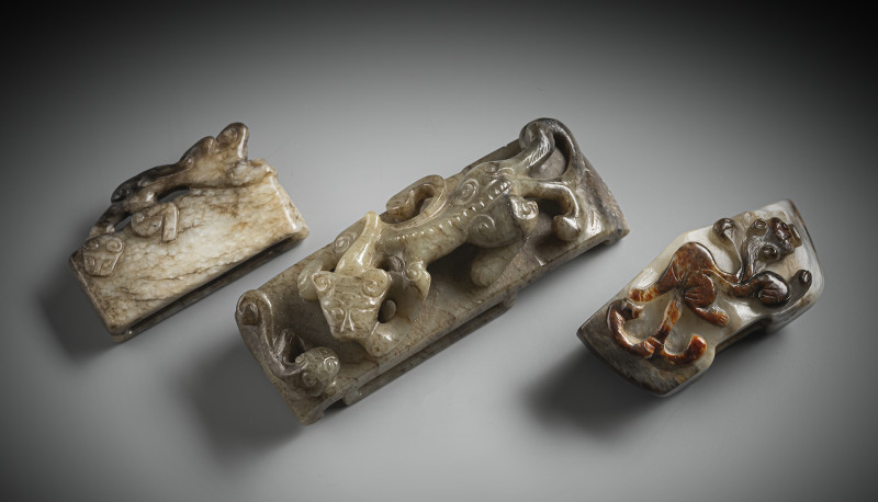 Two sword slides and a belt buckle made of jade, each with chilong in relief