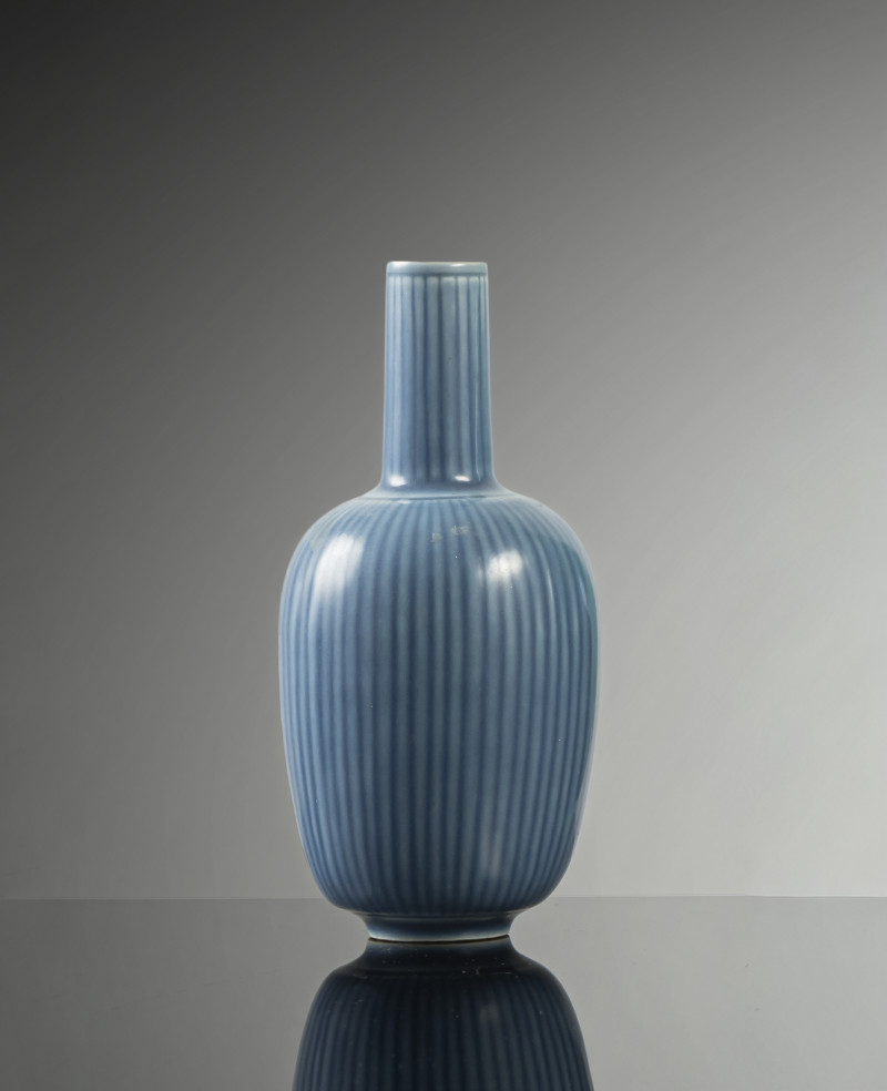 A blue glazed narrow neck porcelain vase with ribbed wall and neck
