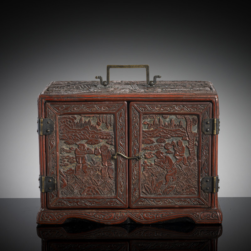 A miniature cinnbar lacquer cabinet with three drawers inside