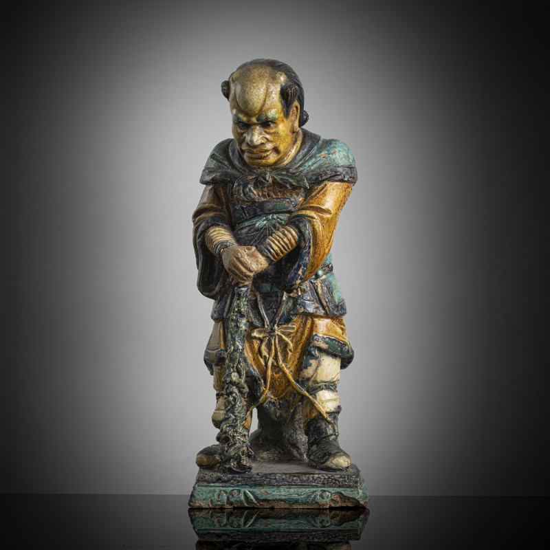A 'fahua' ceramic figure of a lokapala leaning on a club