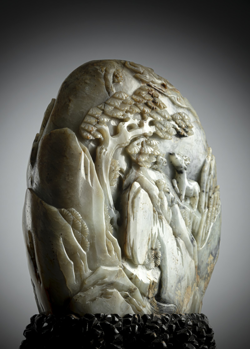 A large carved green jade boulder depicting scholars in a mountain landscape, mounted on a wooden stand - 图3