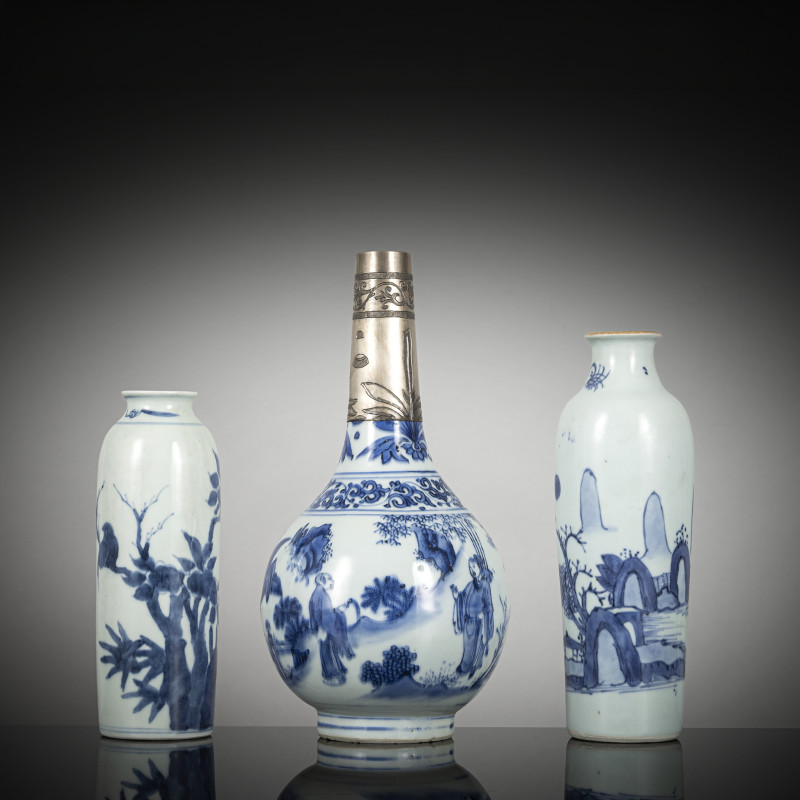 Two small sleeve vases and a porcelain bottle vase with underglaze blue decoration