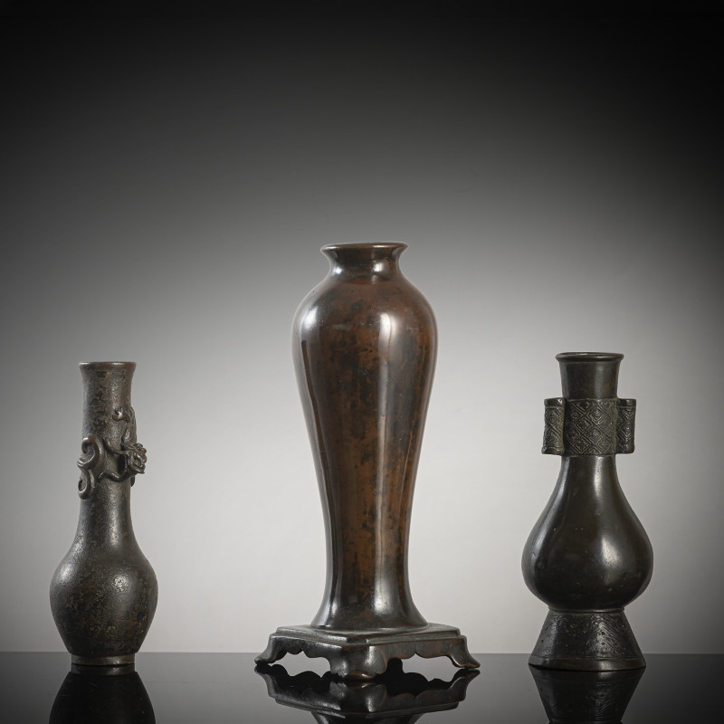 A group of three bronze vases