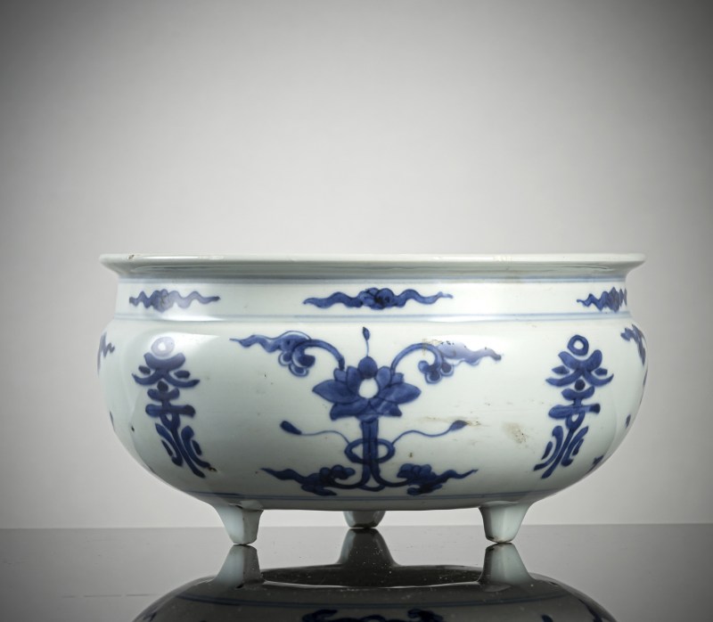A porcelain censer on three short feet with underglaze blue decoration of lotus, foliage and 'shou' characters
