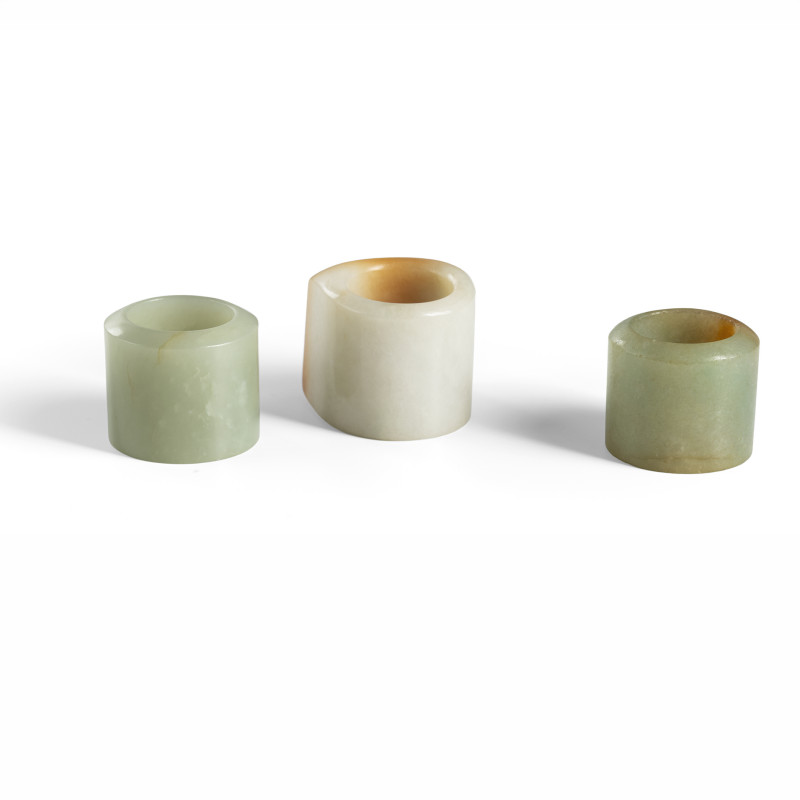 A group of three archer's thumb rings made of jadeite or jade and carving