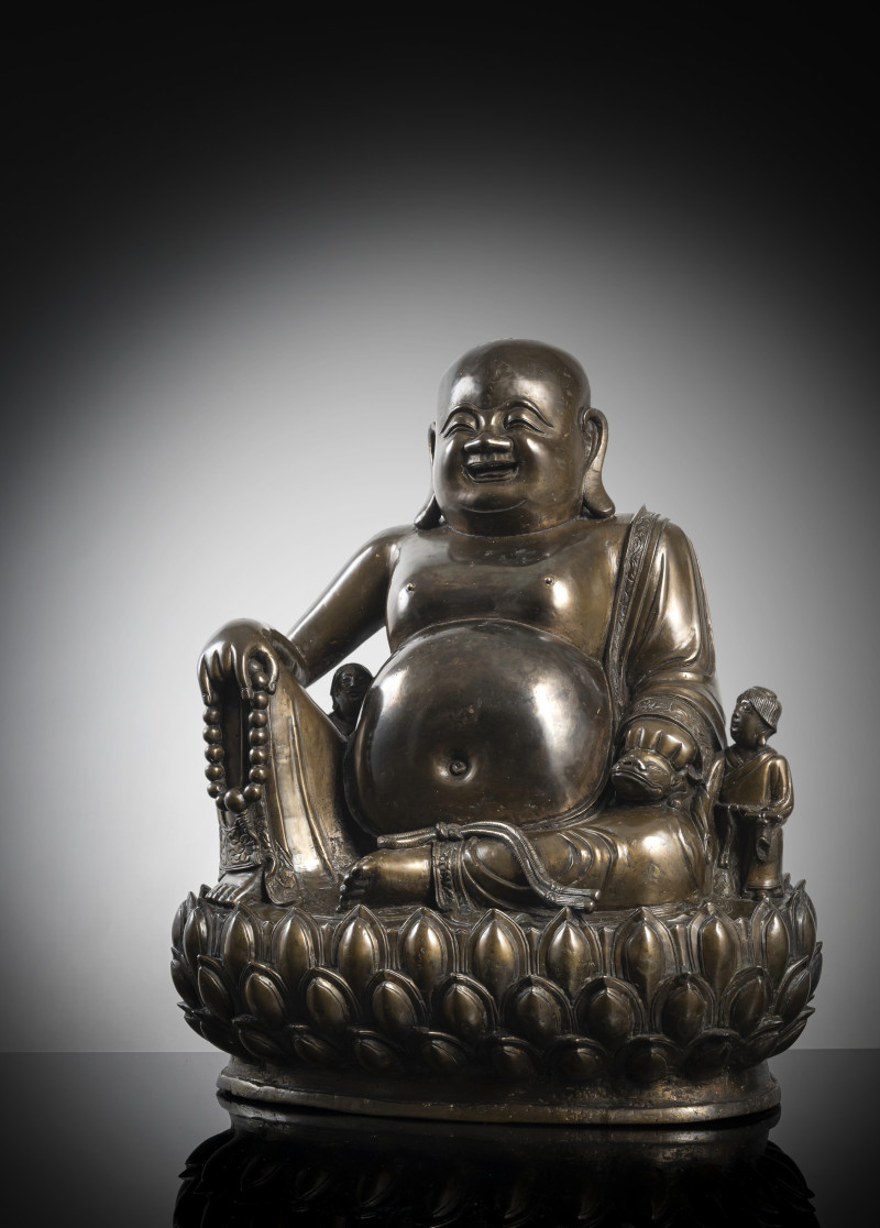 A large cast bronze figure of seated Budai with boys on a lotus pedestal