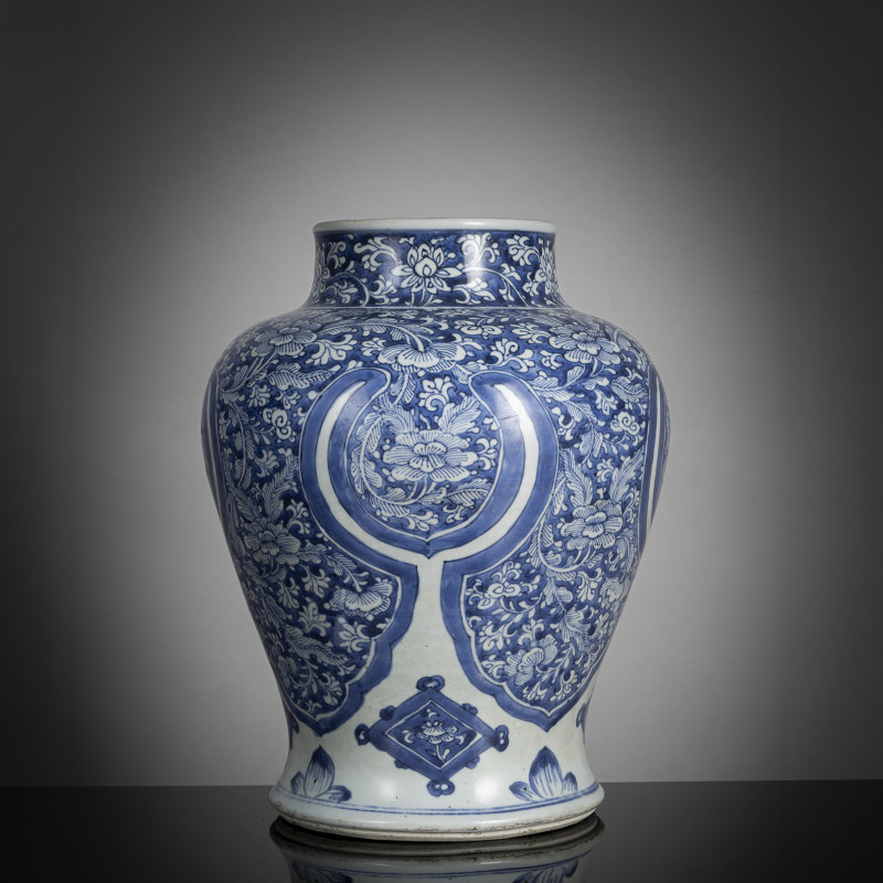 A porcelain vase with dense underglaze blue decoration of blossoms, including lotus