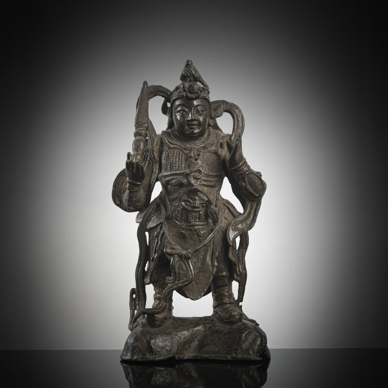 A bronze figure of standing Weituo on a stand dressed in splendid armour with traces of gilding