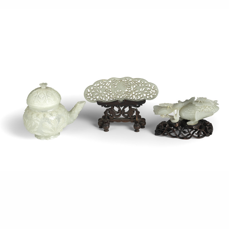 A carved jade teapot and cover and floral decoration in Moghul style, a box and cover with of melon and insects (wooden base) and openwork pendant with phoenix (wooden base)