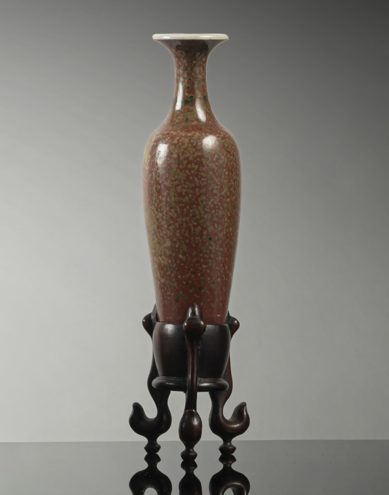 A fine 'Guanyin' porcelain vase with Peachbloom glaze on a wooden stand