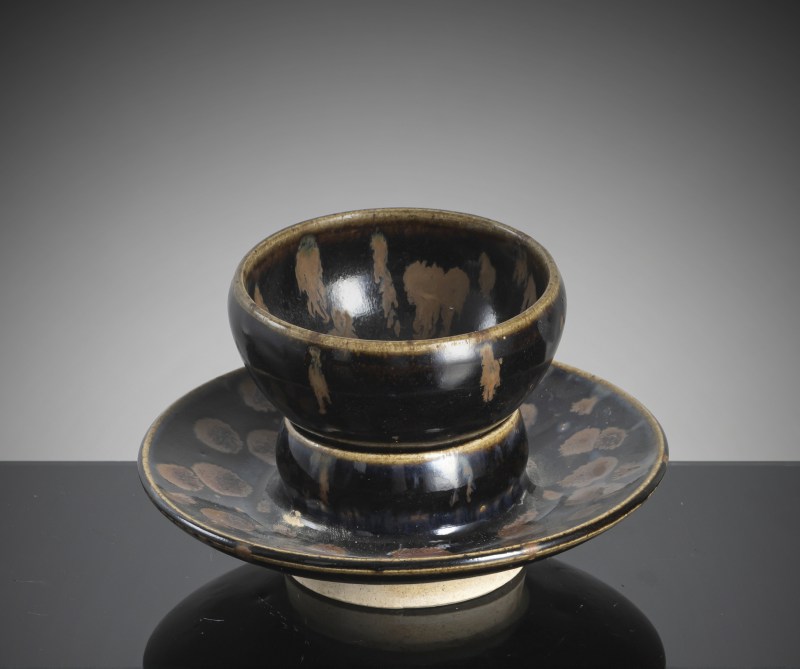 A black-glazed russet-splashed tea bowl on an associated base - 图2