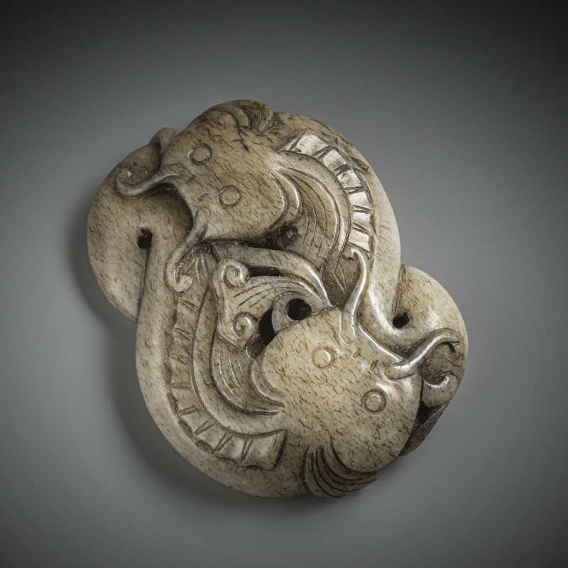 A fine carved grey-green jade pendant in the shape of two catfish