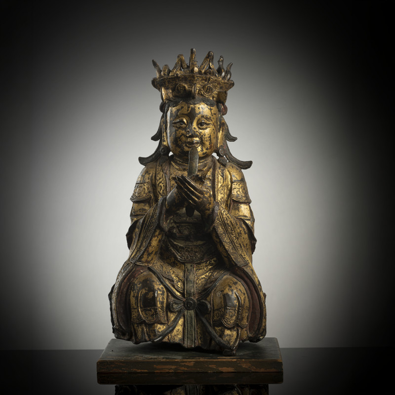 A gilt-lacquered bronze figure of Bixia Yuanjun on a wooden stand
