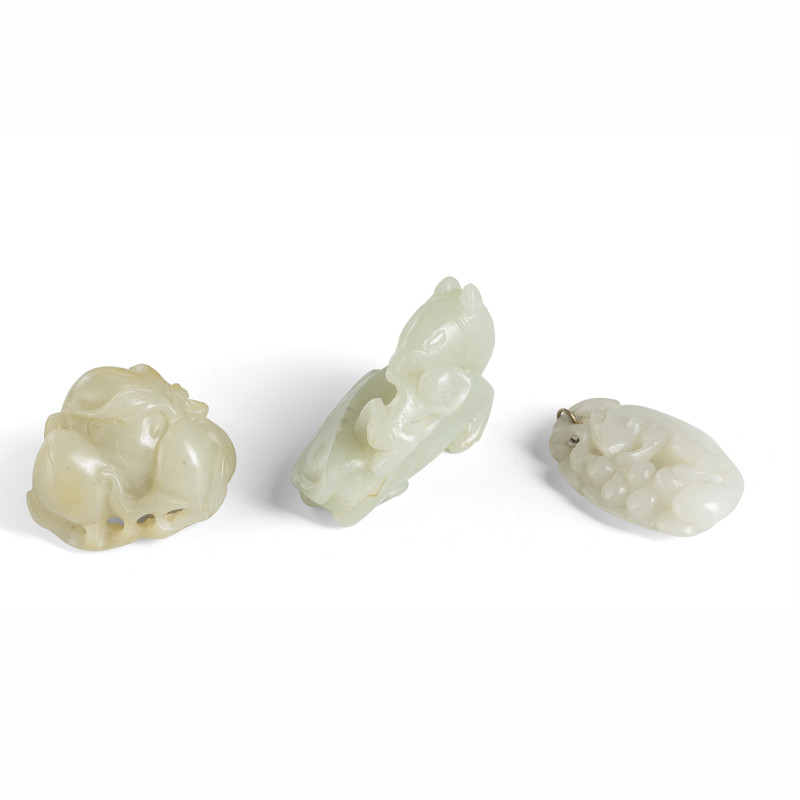 A white jade pendant with squirrel, group of peaches and reclining horse